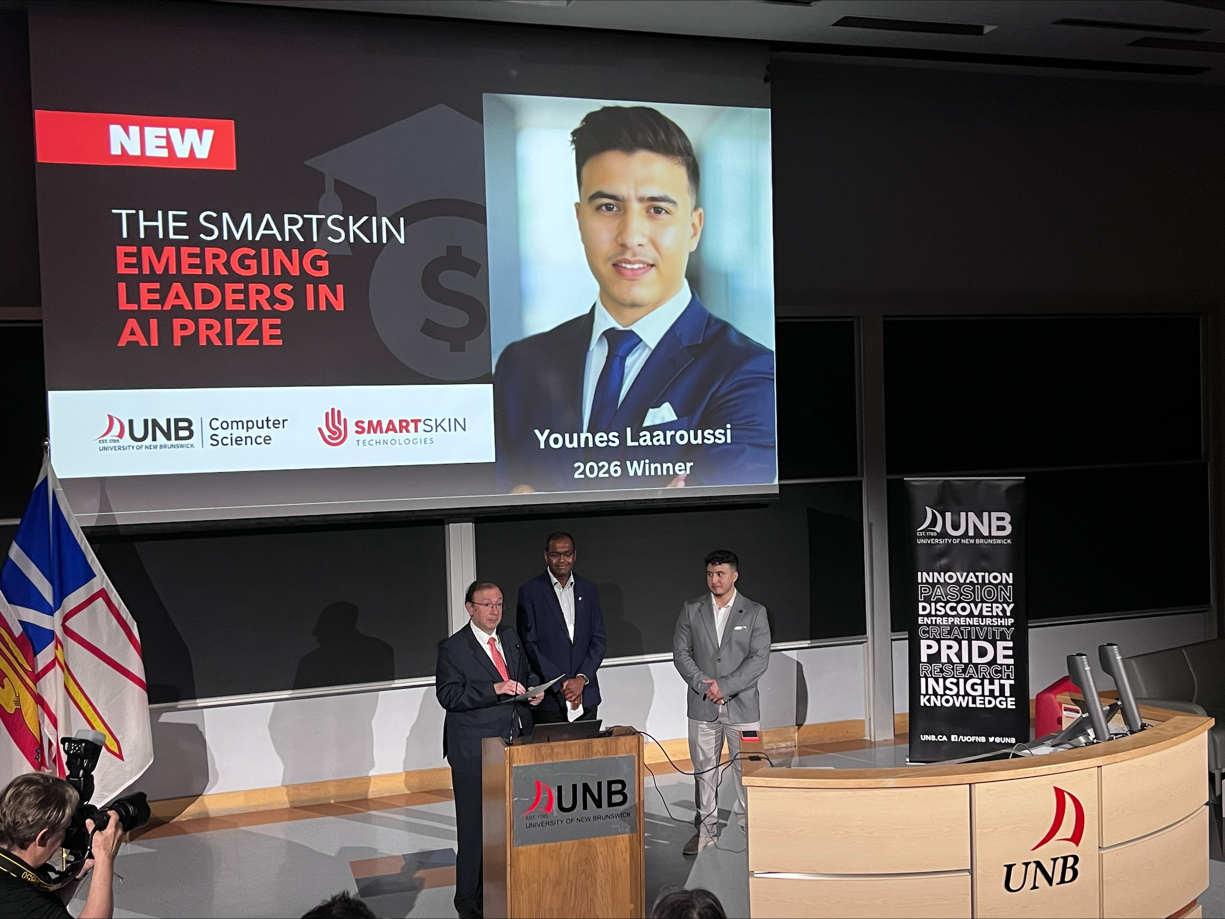 Atlantic AI Summit stage showing Younes Laaroussi announced as the 2026 SmartSkin Emerging Leaders in AI Prize winner.